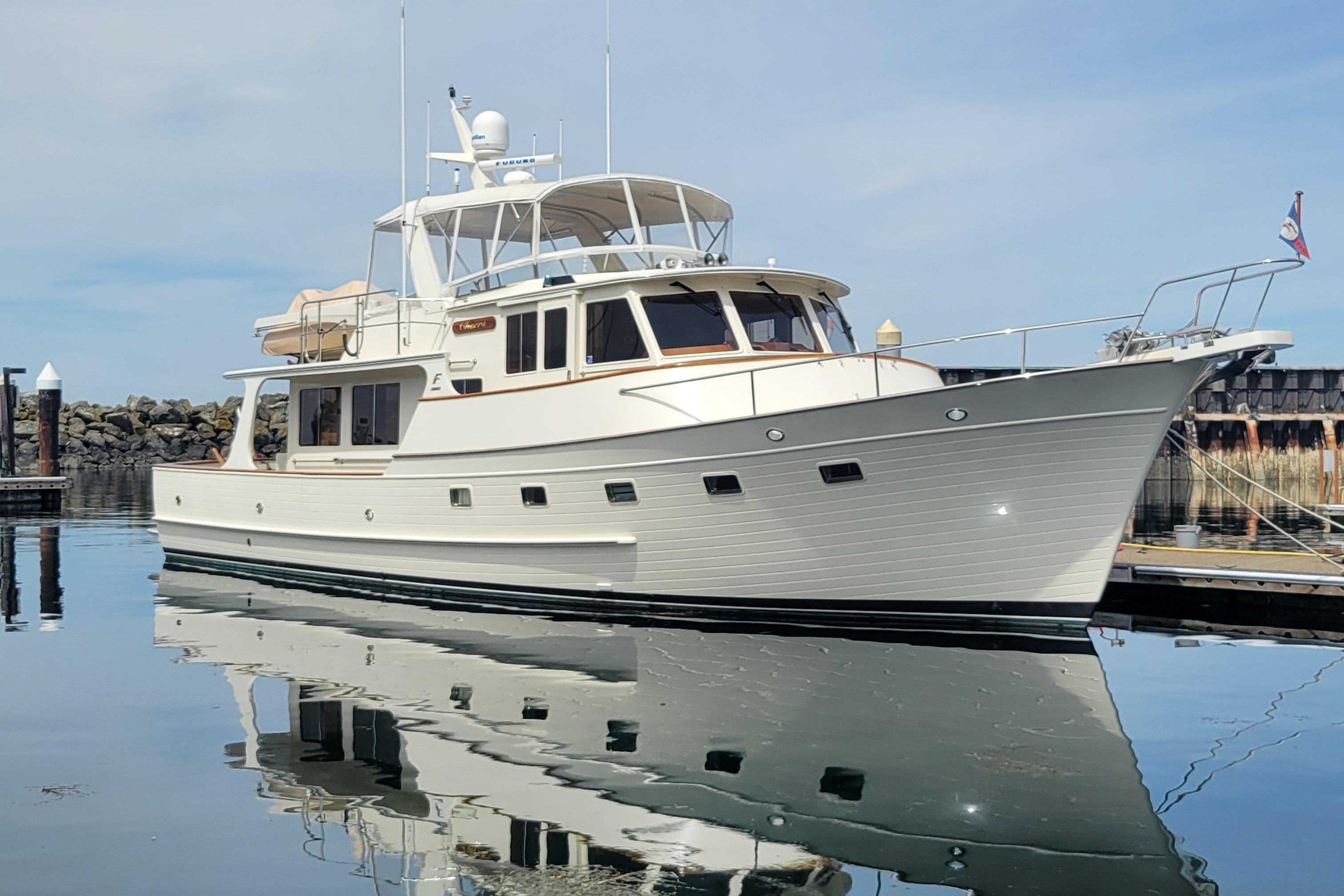 Fleming 55 Pilothouse 2003 Fleming 55 Pilothouse yacht docked in calm waters, reflecting on the surface.