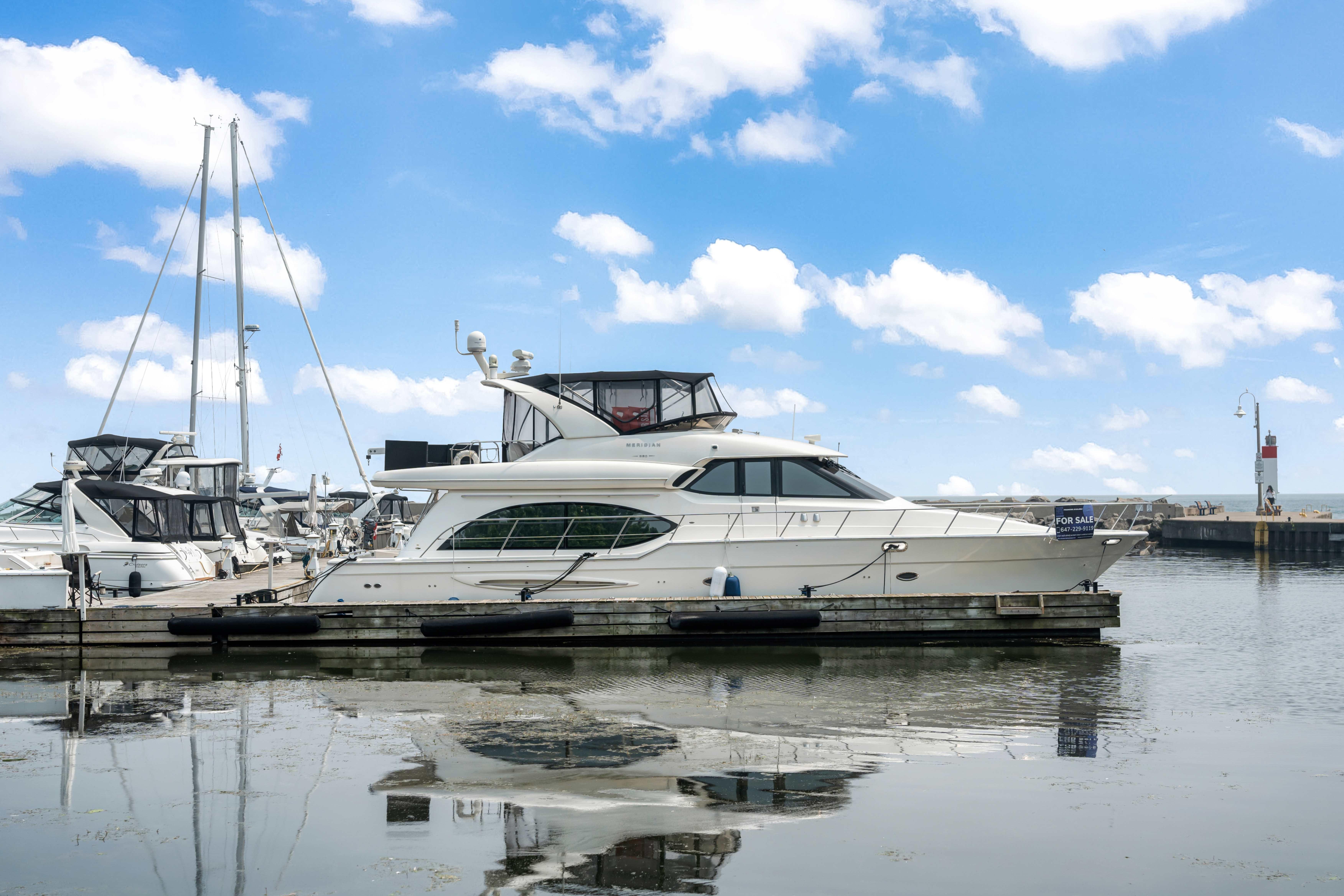 Meridian 580 Pilothouse 2008 Meridian 580 Pilothouse yacht docked at marina under blue sky.