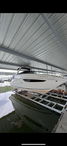 Sea Ray 260 Sundancer 2014 Sea Ray 260 Sundancer boat docked under a metal canopy.