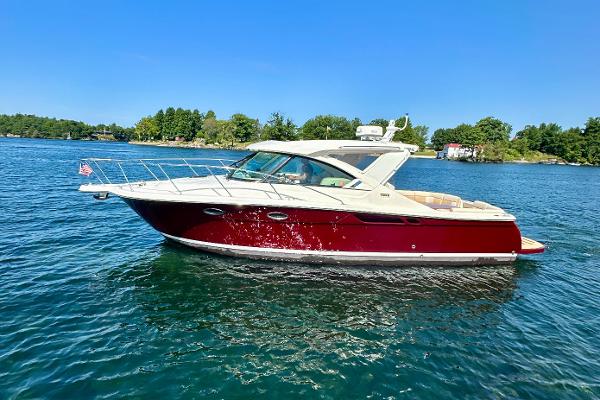 Tiara Yachts 3100 Coronet 2014 Tiara Yachts 3100 Coronet cruising on a serene lake under a clear blue sky.