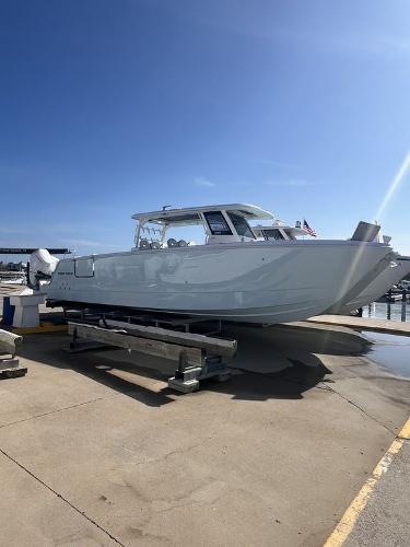 Twin Vee 400 Center Console GFX 2024 Twin Vee 400 Center Console GFX boat on a dock under clear blue sky.