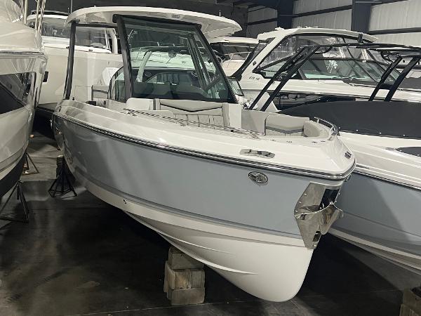 Monterey Elite 27 OB 2025 Monterey Elite 27 OB boat in showroom, sleek design, white and gray exterior.