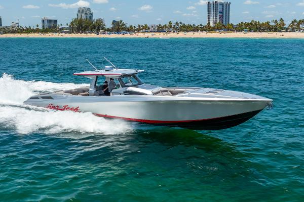 Nor-Tech 560 Sport Center Console 2018 Nor-Tech 560 Sport Center Console cruising on blue ocean near sandy beach.