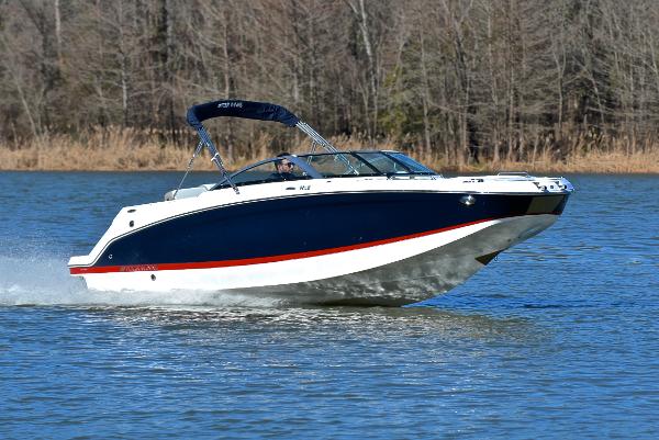 Four Winns HD3 2021 Four Winns HD3 boat cruising on a lake with forested background.