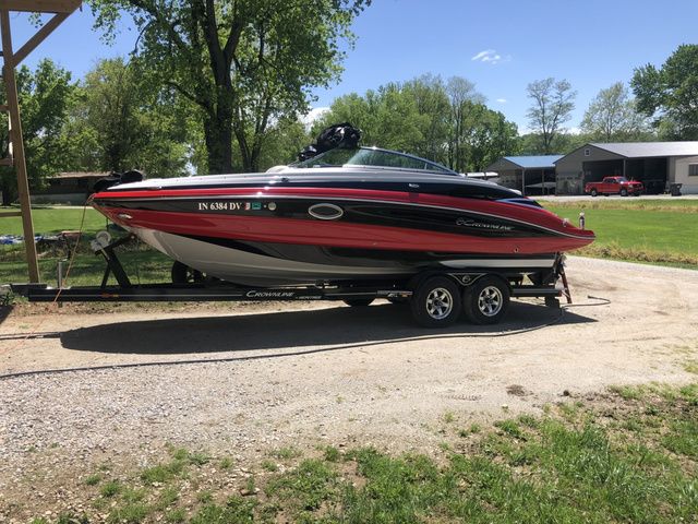Crownline Eclipse E4 2015 Crownline Eclipse E4 boat on trailer, parked outdoors on a sunny day.