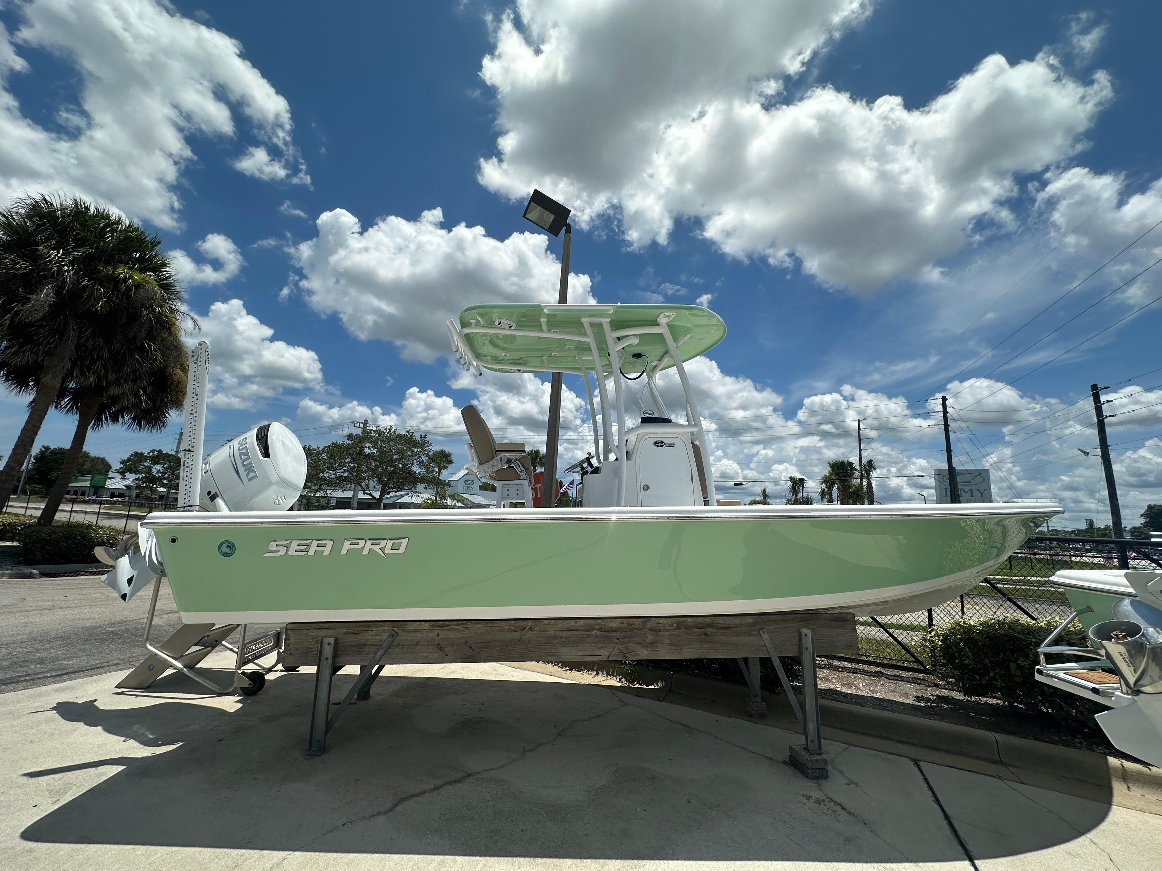 Sea Pro 250 Bay 2026 Sea Pro 250 Bay boat displayed outdoors under a partly cloudy sky.