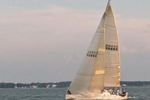 Beneteau First 40.7 Sailing yacht Beneteau First 40.7, 2001 model, gliding on calm waters at sunset.