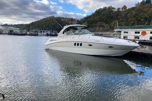 Sea Ray 38 Sundancer 2007 Sea Ray 38 Sundancer yacht docked on a calm lake with scenic background.