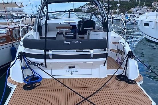 Bavaria S36 Open 2017 Bavaria S36 Open yacht docked in a marina, showcasing sleek design and spacious deck.