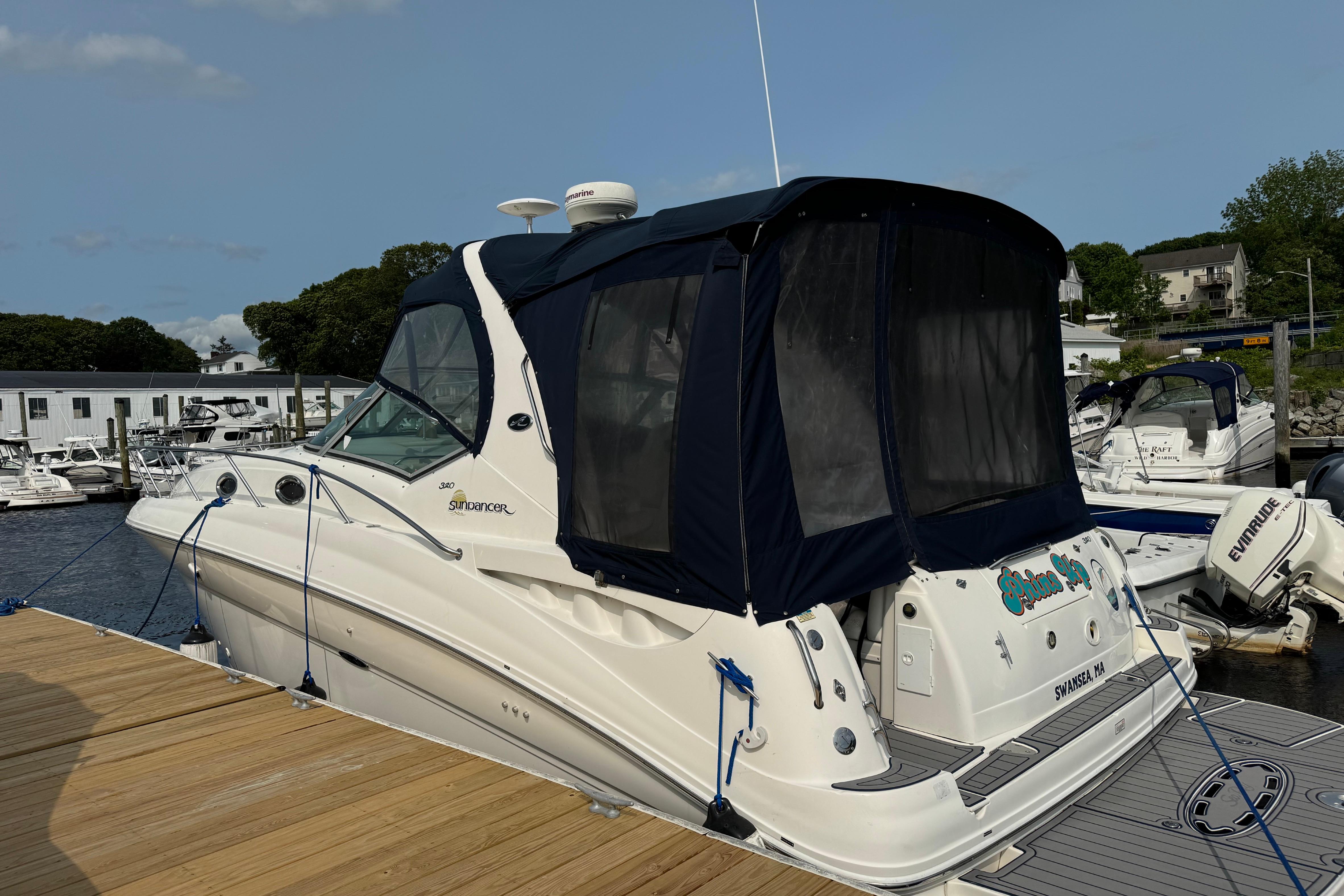 Sea Ray 320 Sundancer 2003 Sea Ray 320 Sundancer docked at marina with blue canopy.