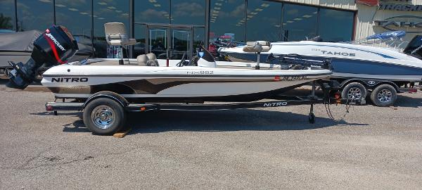 Nitro NX882 2003 Nitro NX882 boat on trailer, parked outdoors near showroom.