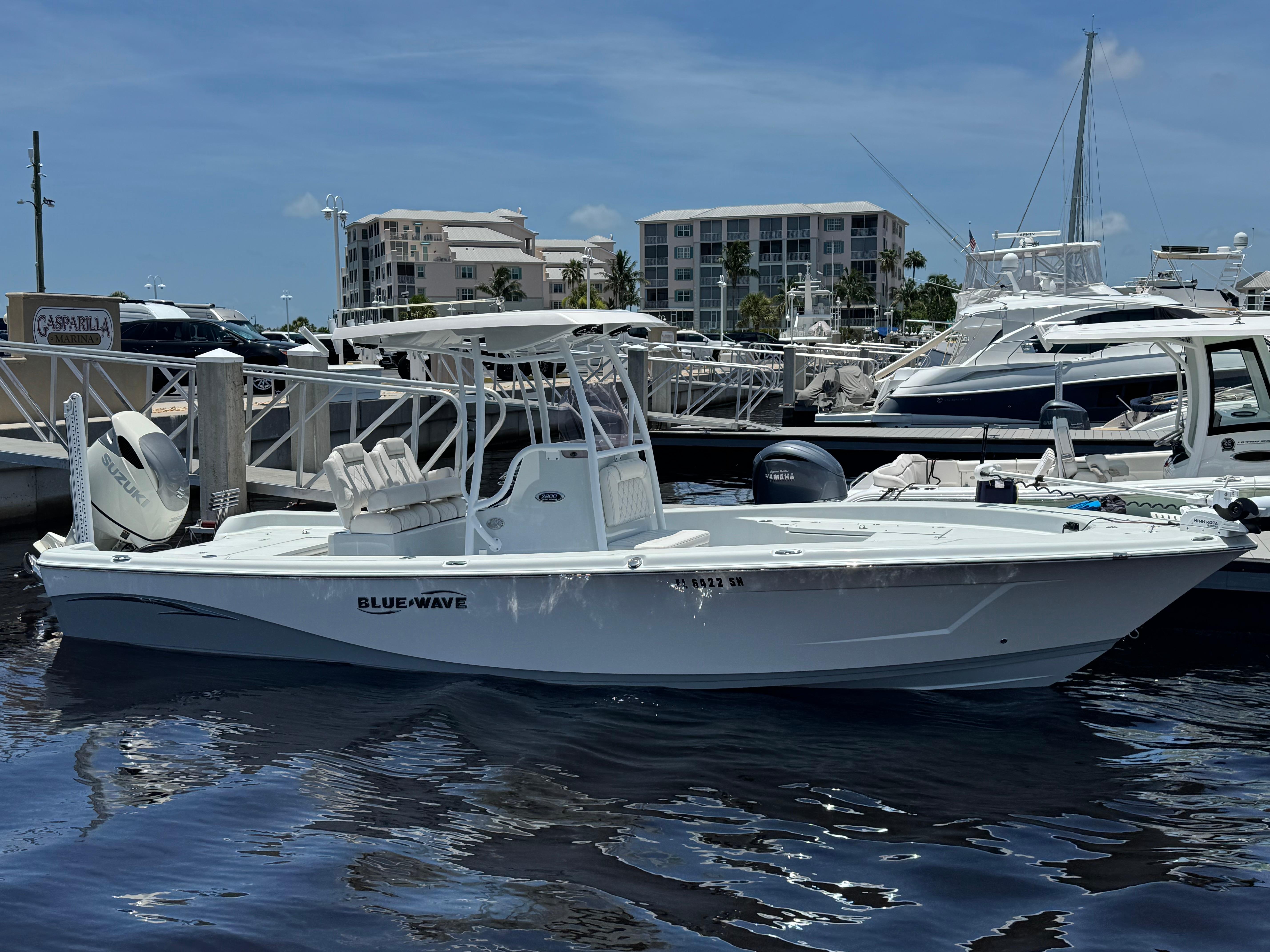 Blue Wave 2800 Pure Hybrid 2019 Blue Wave 2800 Pure Hybrid boat docked at marina under clear blue sky.