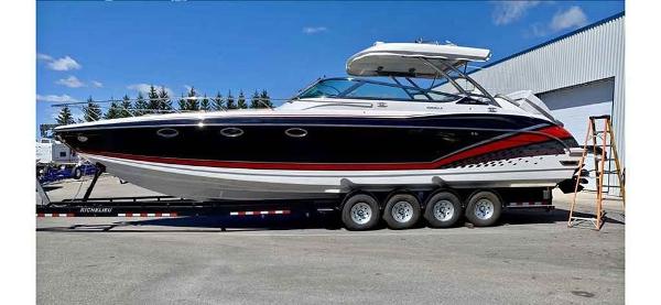 Formula 370 FX 2017 Formula 370 FX boat on trailer, sleek design, black and red accents, parked outdoors.