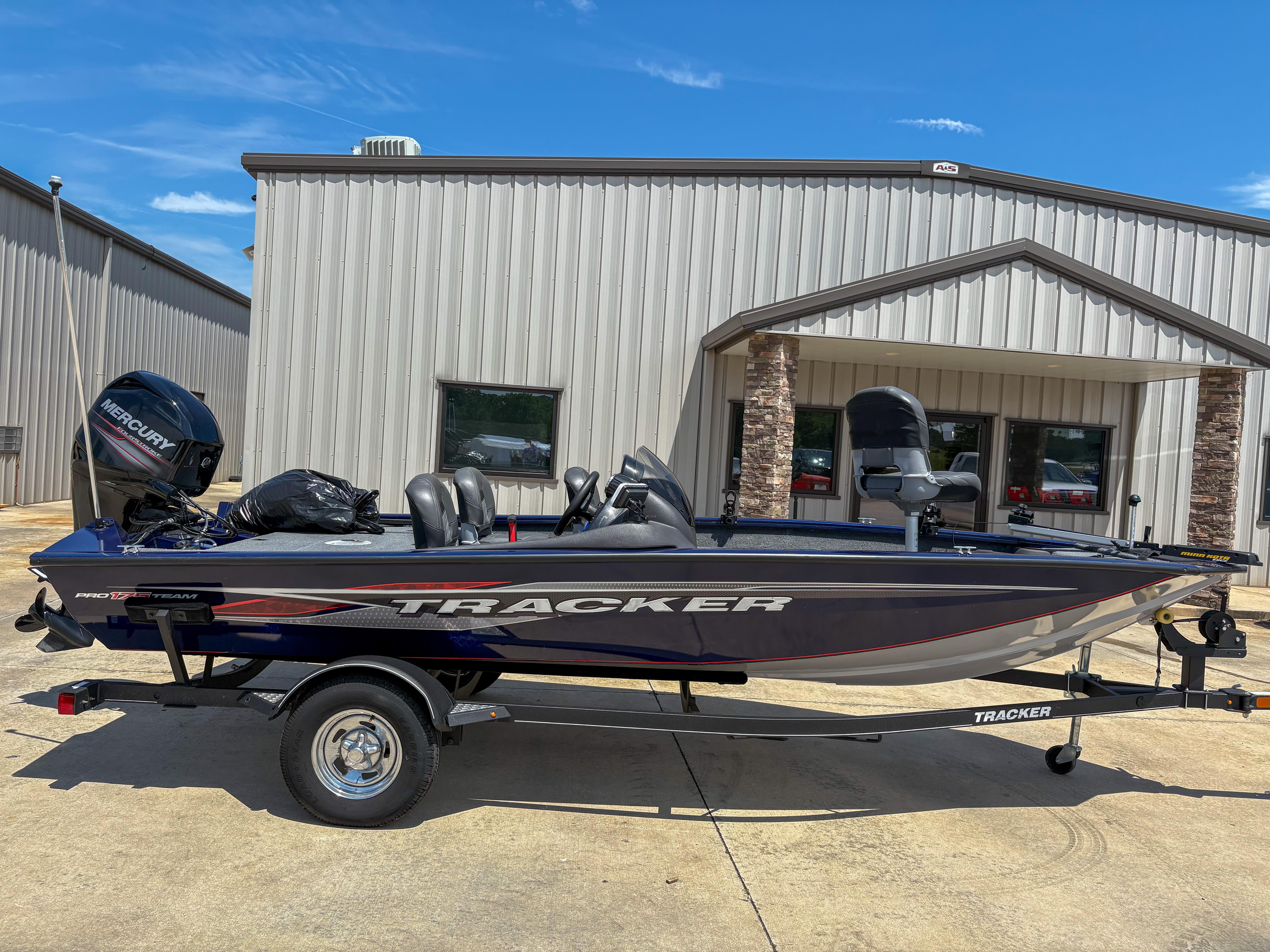 Tracker Pro Team 175 TF 2019 Tracker Pro Team 175 TF boat on trailer, parked outside a metal building.