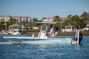 Avenger AV24 2017 Avenger AV24 boat cruising on a calm waterway near residential area.