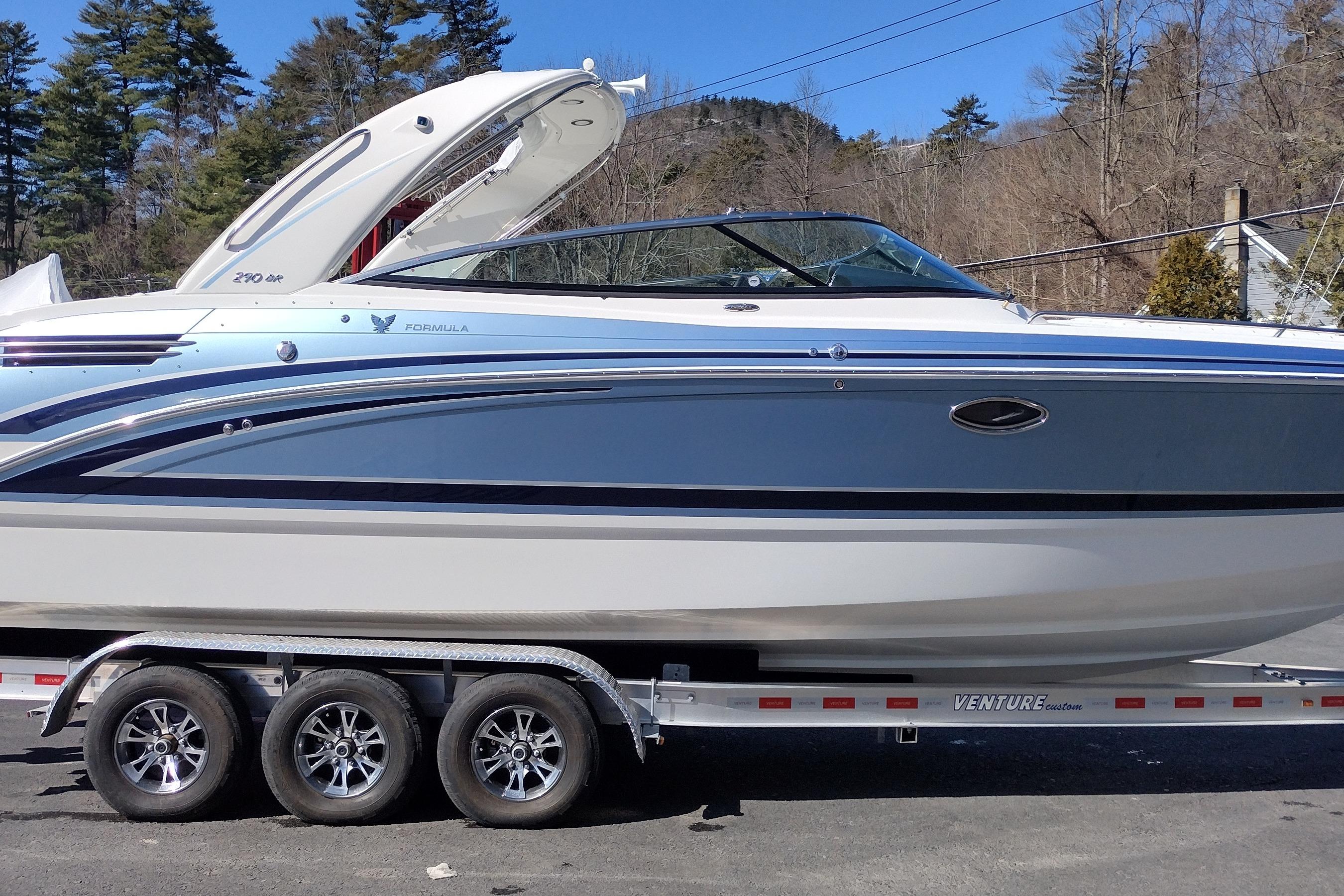 Formula 290 Bowrider 2024 Formula 290 Bowrider boat on trailer, side view, outdoors.