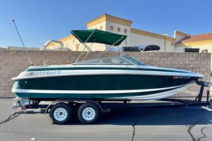 Cobalt 232 1996 Cobalt 232 boat on trailer, green and white, parked outdoors.