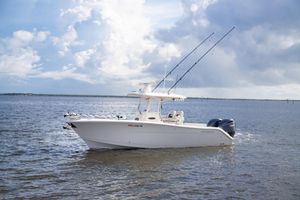 Cobia 280 Center Console 2023 Cobia 280 Center Console boat on open water under cloudy sky.