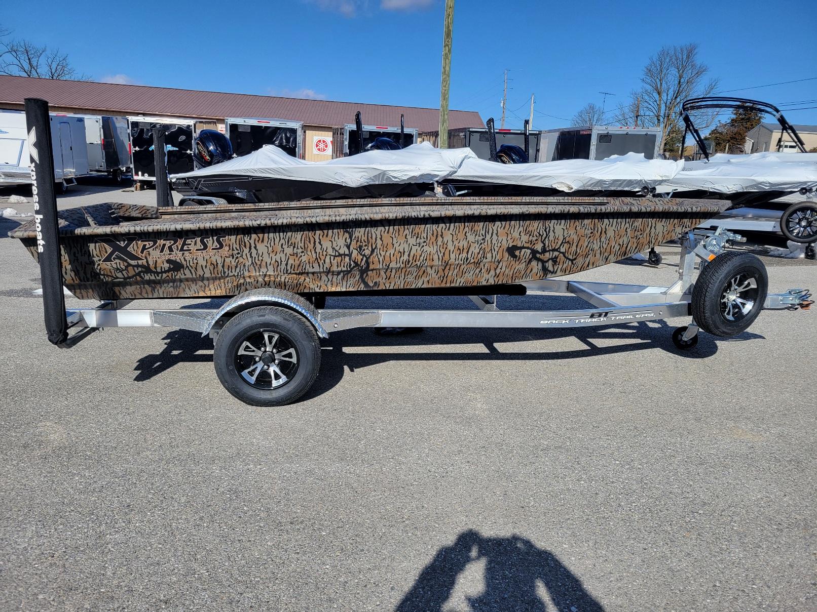 Xpress HD15DBX, 15' duck hunting boat. (In stock!) 2024 Xpress HD15DBX duck hunting boat on trailer, camo design, in stock.