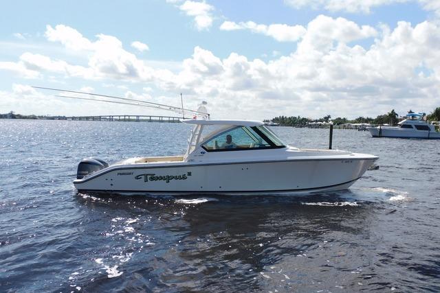 Pursuit DC 325 Dual Console 2016 Pursuit DC 325 Dual Console boat cruising on a sunny day.