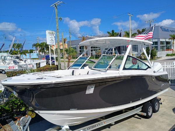 Blackfin 272 DC 2024 Blackfin 272 DC boat on trailer, displayed outdoors under clear blue sky.