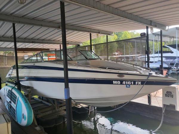 Crownline 248 BR 2001 Crownline 248 BR boat docked under a covered marina.