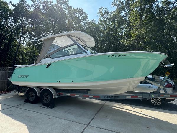 Blackfin 272 DC 2020 Blackfin 272 DC boat on trailer, parked outdoors.