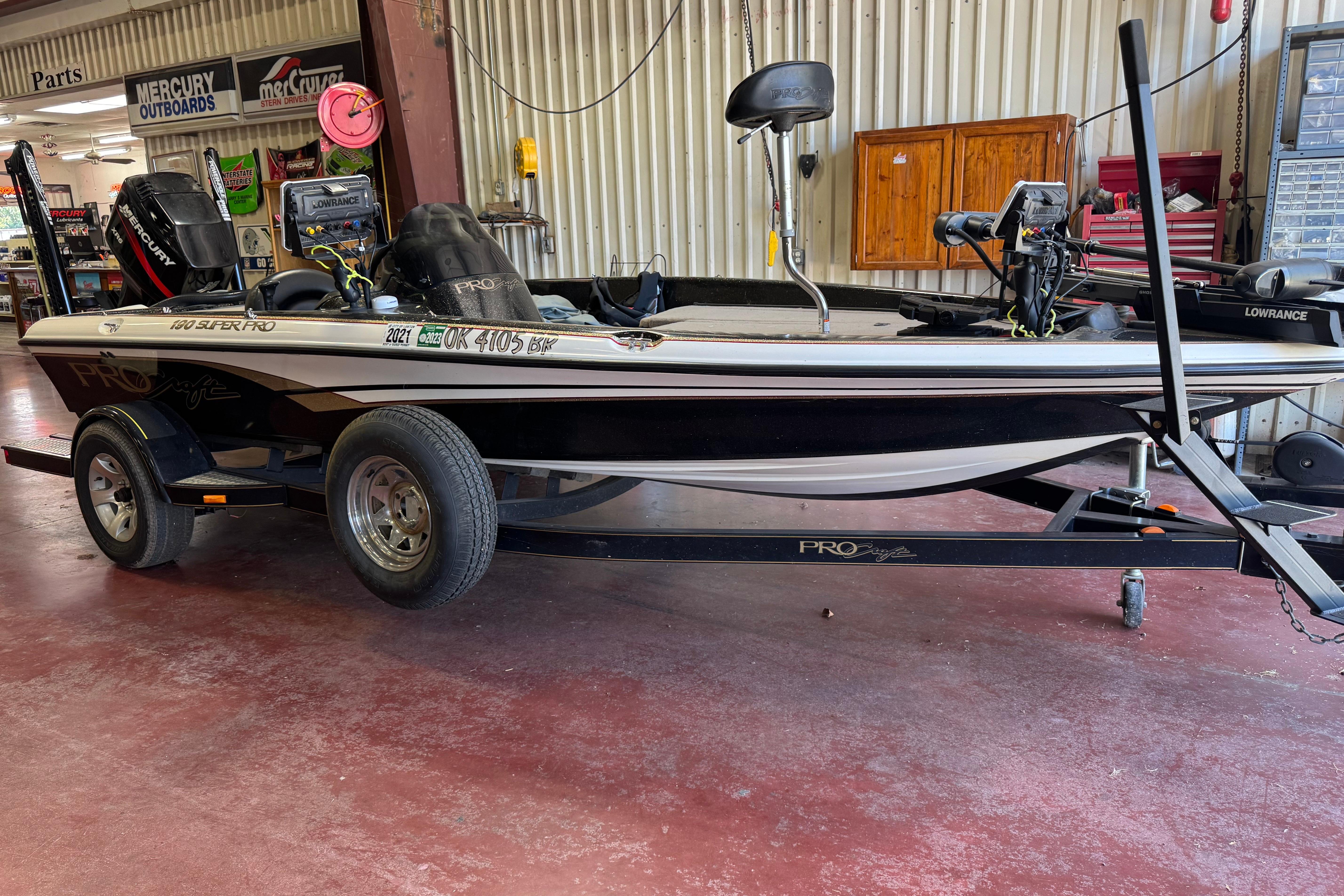 ProCraft 190 Super Pro SC/DC 2003 Tracker Pro 160 boat on trailer in a garage setting.