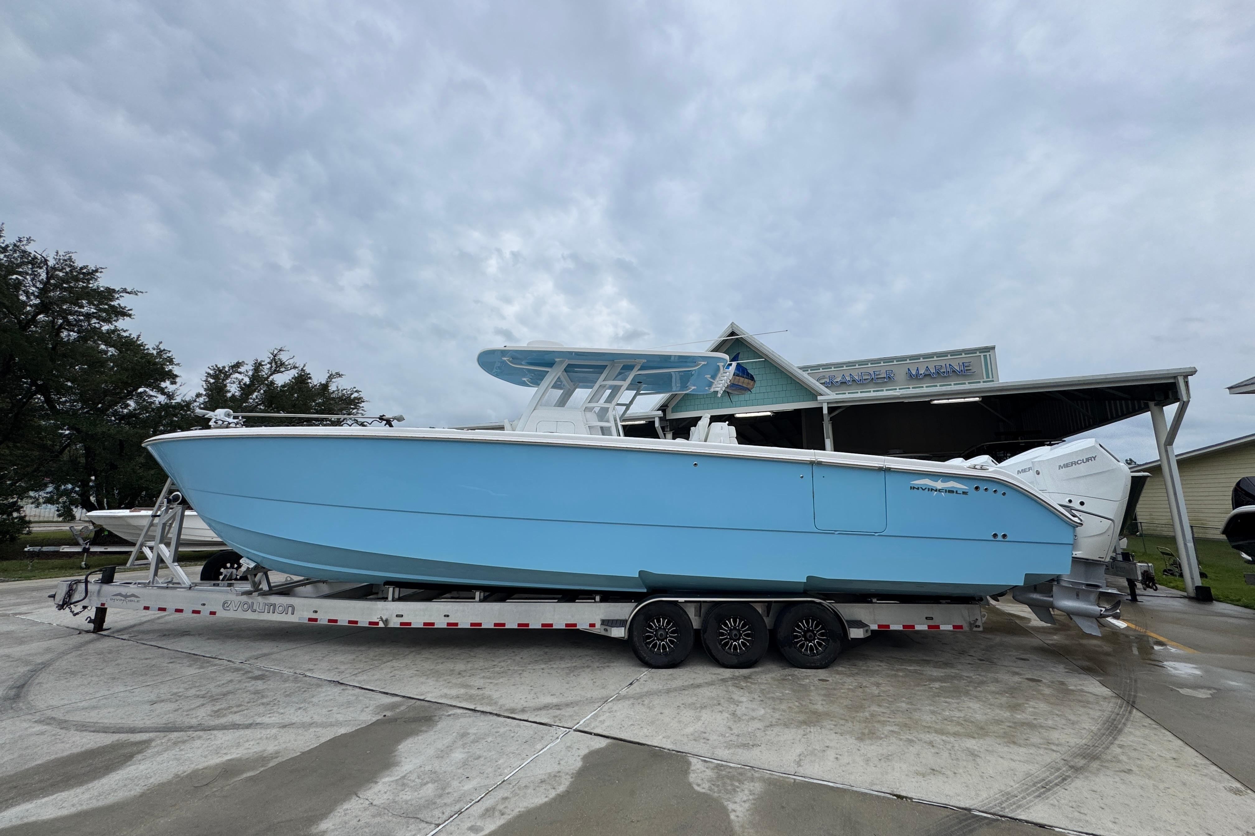 Invincible 40 Catamaran 2025 Invincible 40 Catamaran in light blue on a trailer, parked outdoors.