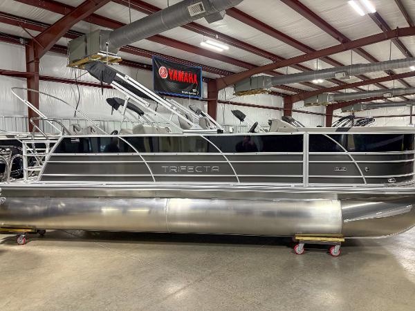 Trifecta 22 RF LE 2024 Trifecta 22 RF LE pontoon boat in showroom, side view.
