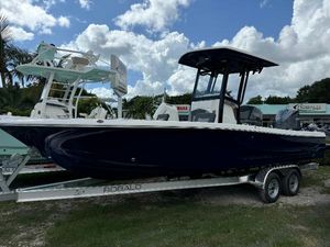 Robalo 246 Cayman 2025 Robalo 246 Cayman boat on trailer under cloudy sky.