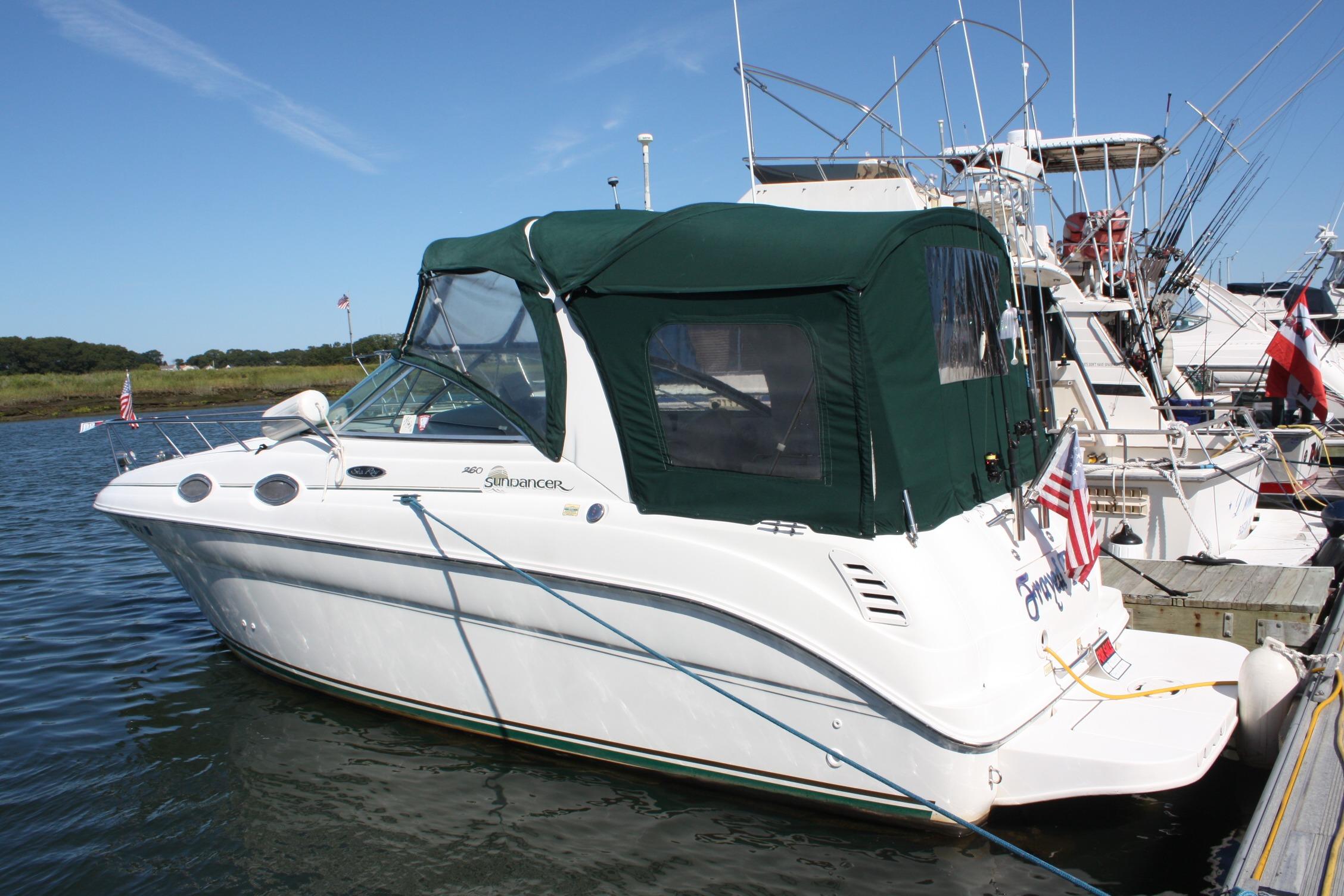 Sea Ray 260 Sundancer 2003 Sea Ray 260 Sundancer boat docked with green canopy and American flag.