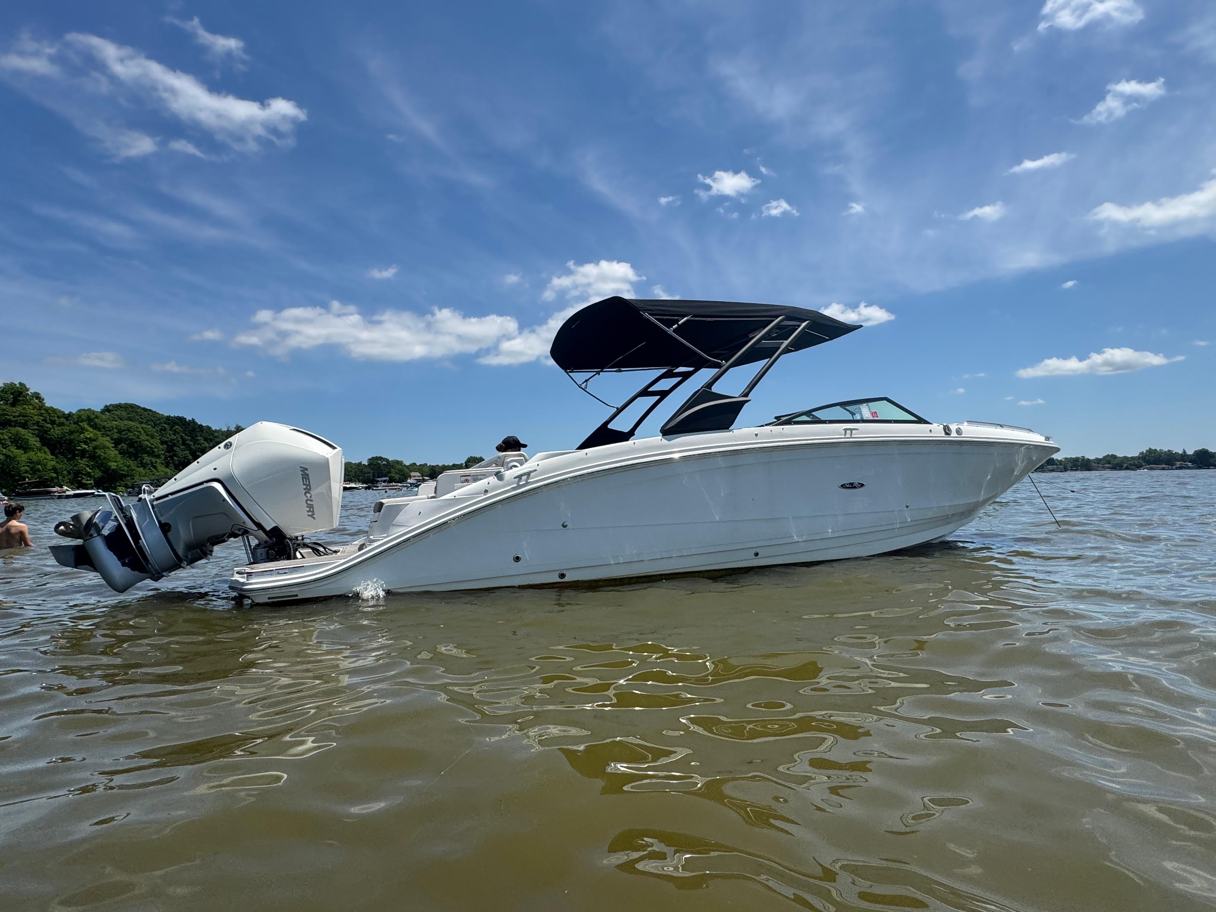 Sea Ray SDX 290 Outboard 2023 Sea Ray SDX 290 Outboard boat on water under clear blue sky.