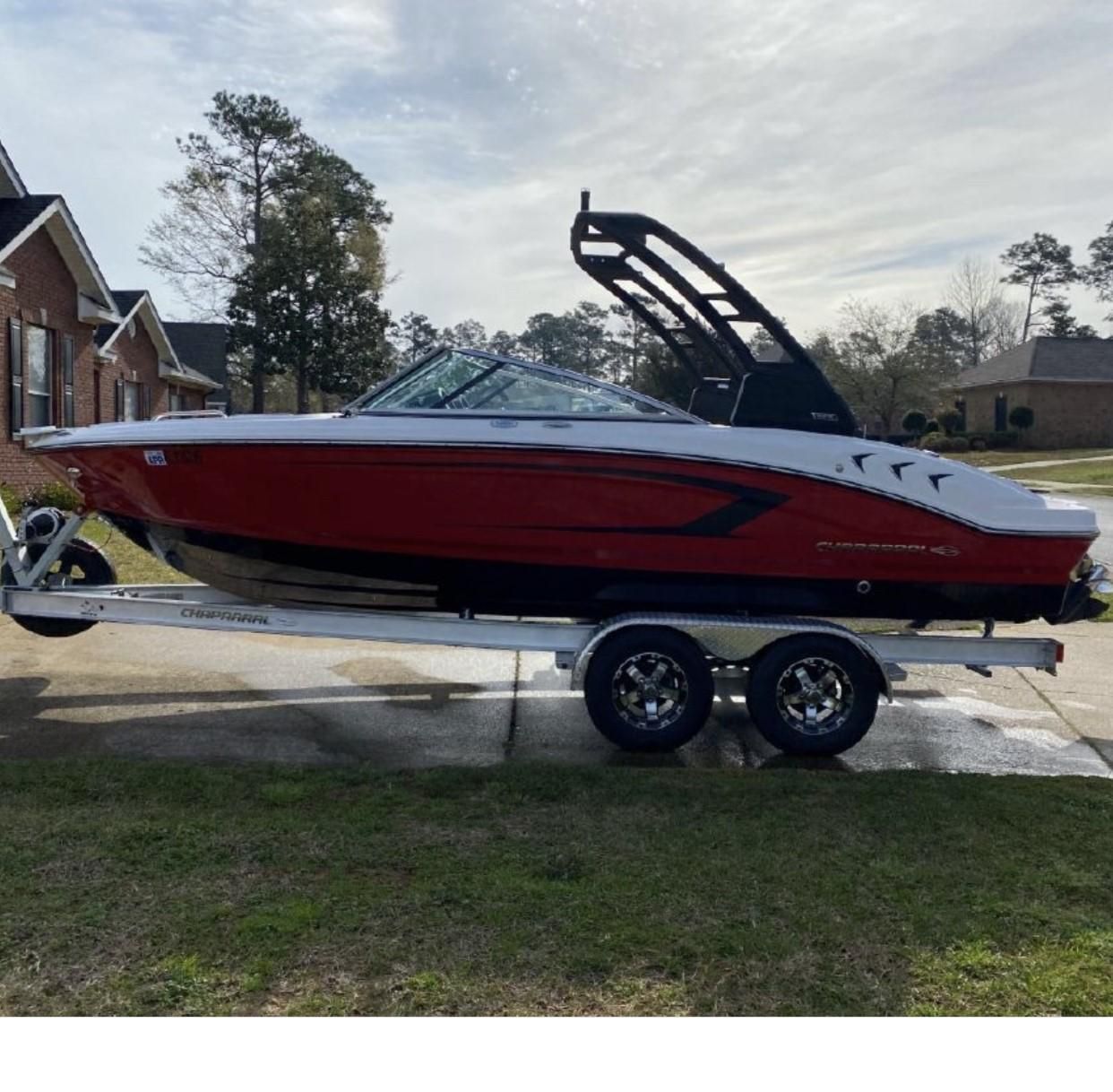 Chaparral 21 SSi Ski & Fish 2020 Chaparral 21 SSi Ski & Fish boat on trailer, parked in residential area.