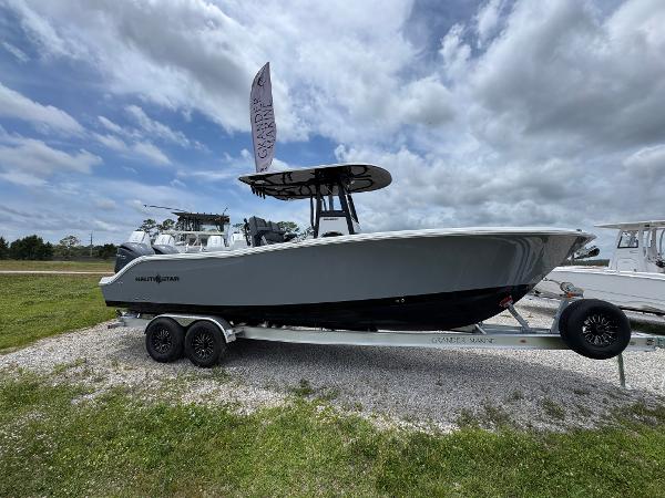 NauticStar 292 Legacy 2025 NauticStar 292 Legacy boat on trailer under cloudy sky.