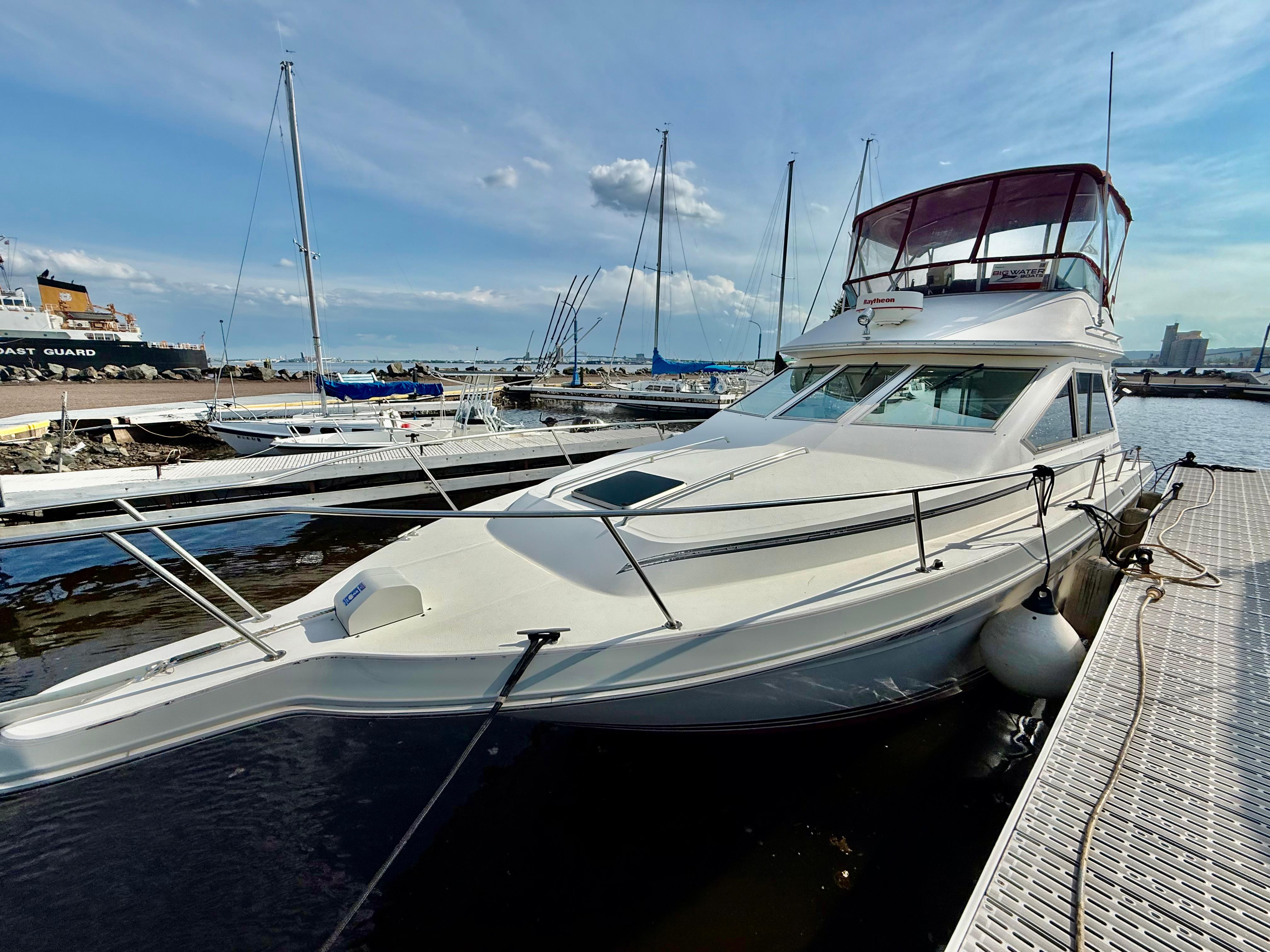 Sea Ray 345 Sedan Bridge 1988 Sea Ray 345 Sedan Bridge yacht docked at marina under clear sky.