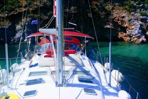 Beneteau Oceanis Clipper 473 2003 Beneteau Oceanis Clipper 473 yacht anchored in clear turquoise waters near rocky cliffs.