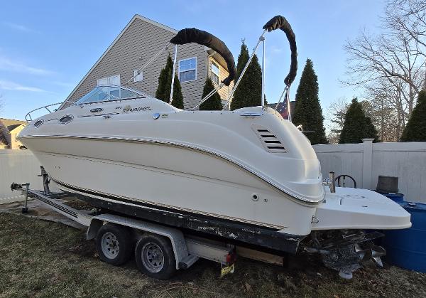Sea Ray 240 Sundancer 2001 Sea Ray 240 Sundancer boat on trailer, parked in residential yard.