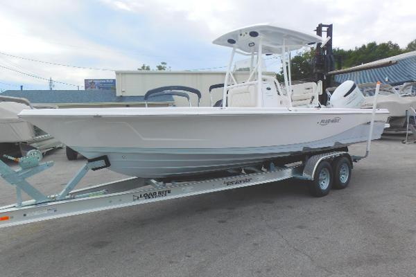 Blue Wave 2600 PureBay 2024 Blue Wave 2600 PureBay boat on a trailer in a marina.
