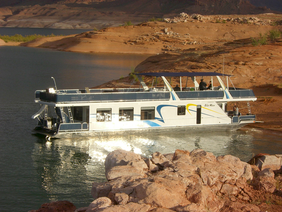 Sumerset BLue Moon Share #12 2008 Sumerset Blue Moon Share #7 houseboat on a serene lake with rocky shoreline.