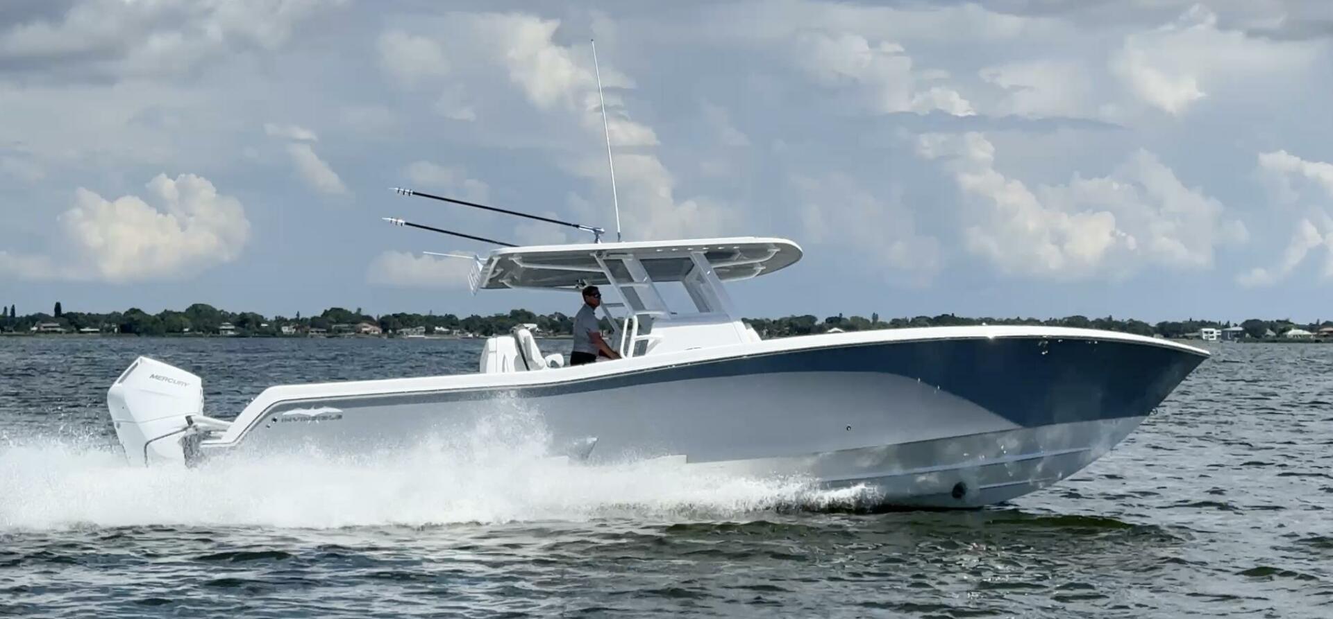 Invincible 39 Open Fisherman 2025 Invincible 39 Open Fisherman boat cruising on water under cloudy sky.