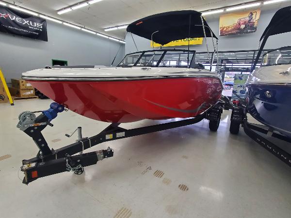 Bayliner 190 Deck Boat 2024 Bayliner 190 Deck Boat in showroom, red hull, on trailer.