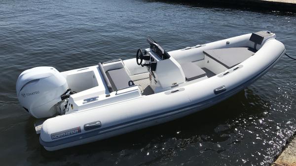 Northstar Axis 4.8 2021 Northstar Axis 4.8 boat with Tohatsu engine on calm water.