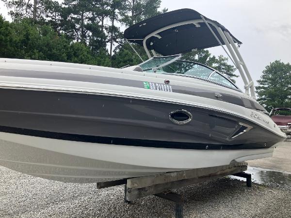 Crownline Eclipse E25 2018 Crownline Eclipse E25 boat with canopy, displayed outdoors on a stand.