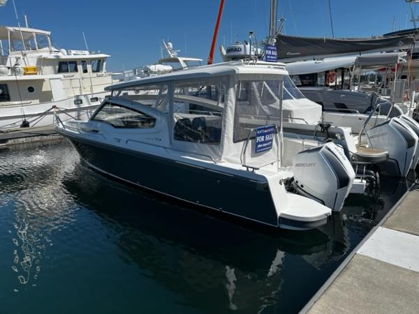 Nimbus W9 2023 Nimbus W9 boat for sale at marina, featuring twin Mercury engines.