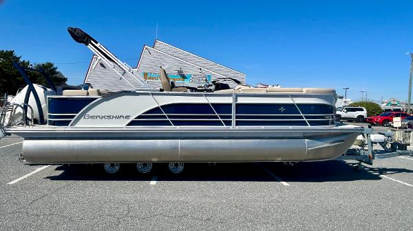 Berkshire 23CL STS 3.0 2025 Berkshire 23CL STS 3.0 pontoon boat parked in a lot under clear blue sky.