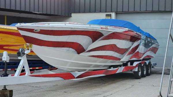 Formula 382 FASTech 2004 Formula 382 FASTech boat with red and white design on a trailer.