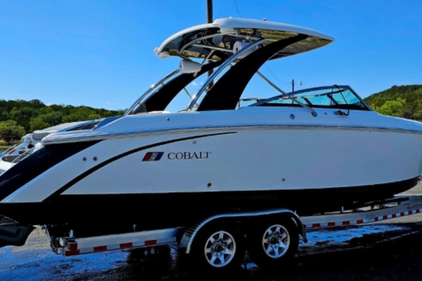 Cobalt R30 2023 Cobalt R30 boat on trailer, sleek design, parked outdoors.