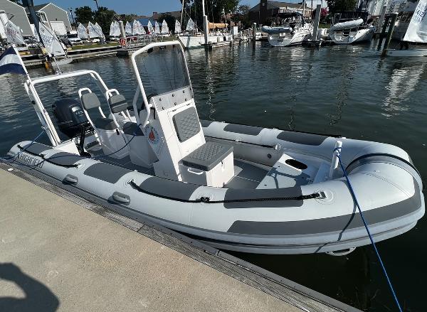 Highfield Patrol 540 2023 Highfield Patrol 540 boat docked at marina, featuring sleek design and modern equipment.