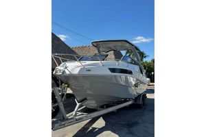 NX Boats NX290 2024 NX Boats NX290 on trailer, sleek design under clear blue sky.